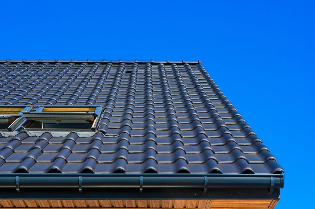 Finished blue roof on a residential property in a suburban neighborhood.